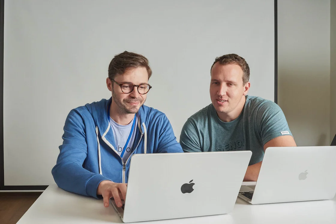 Two Cobrowse software developers, João and Ross, working on their computers
